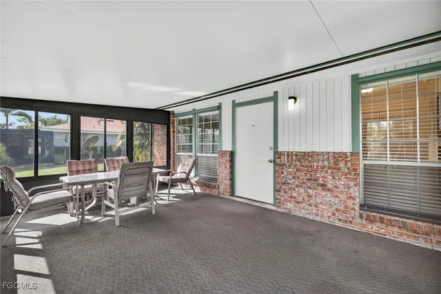 a living room with furniture and large windows