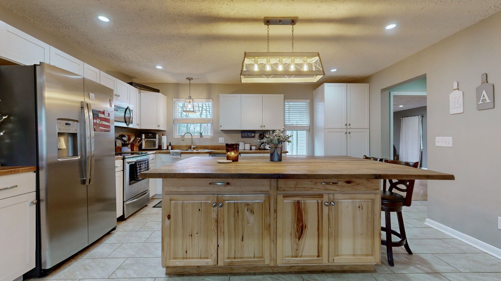 3182 Cairo Bend Road Lebanon, TN 37087 - Photo 11 of 51 a view of a kitchen with a center island and stainless steel appliances