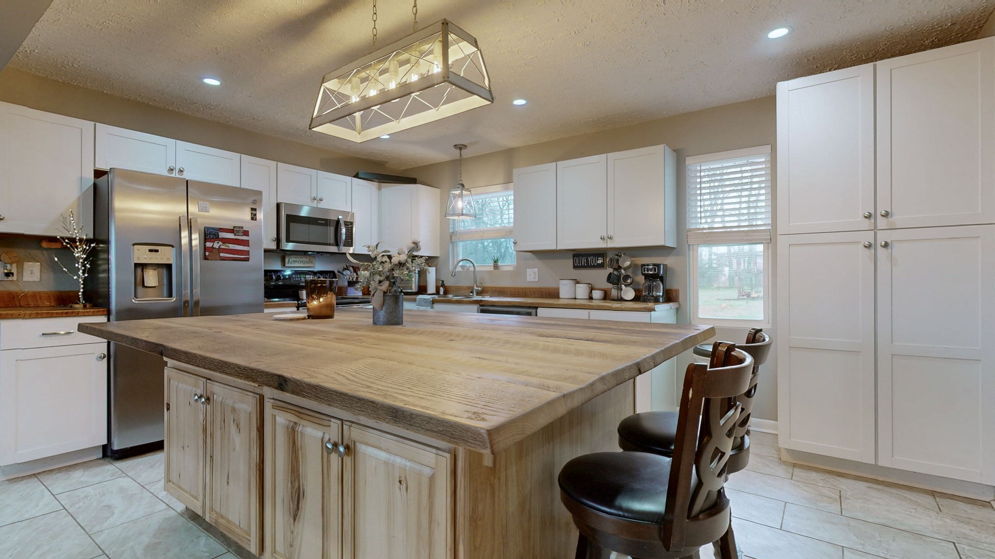 3182 Cairo Bend Road Lebanon, TN 37087 - Photo 12 of 51 a kitchen with kitchen island a stove a table and chairs in it