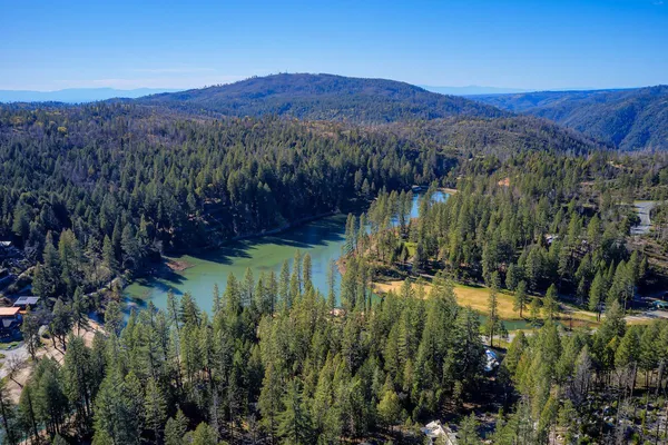 a view of a lush green hillside and a mountain