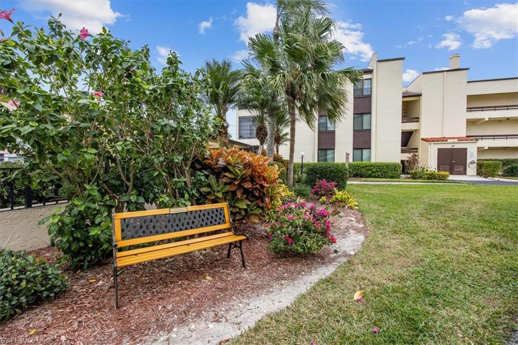 3635 Boca Ciega Drive, Unit 207 Naples, FL 34112 - Photo 22 of 24 a view of a backyard with plants and a garden