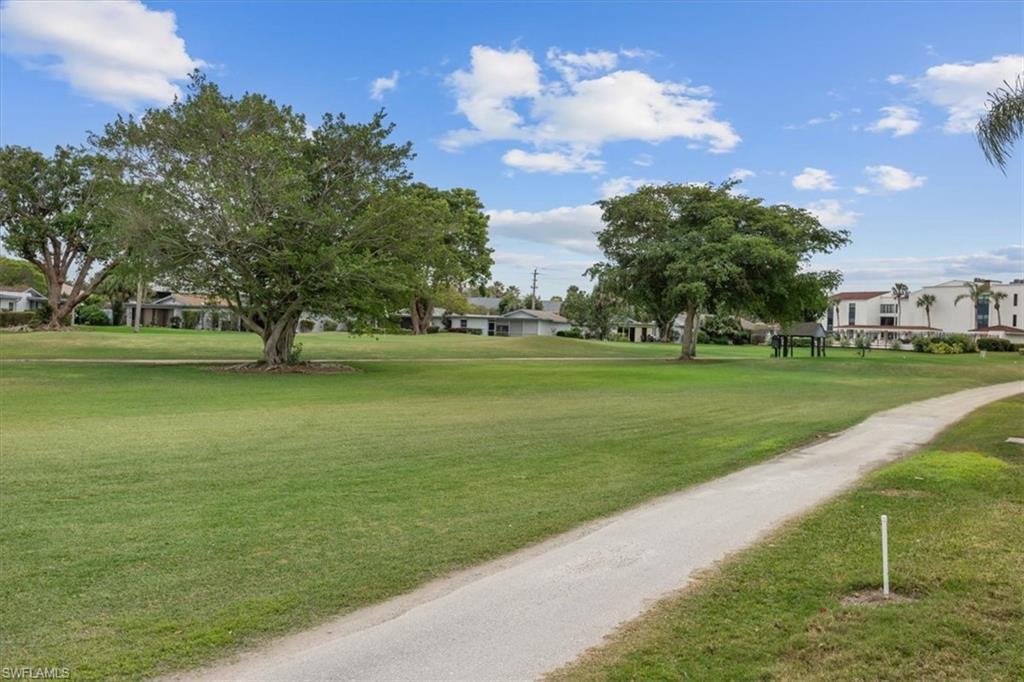 3635 Boca Ciega Drive, Unit 207 Naples, FL 34112 - Photo 24 of 24 a view of a golf course with a lake