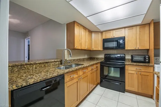a kitchen with stainless steel appliances granite countertop a stove sink and microwave