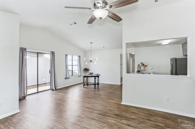 a view of a work space with wooden floor and a window