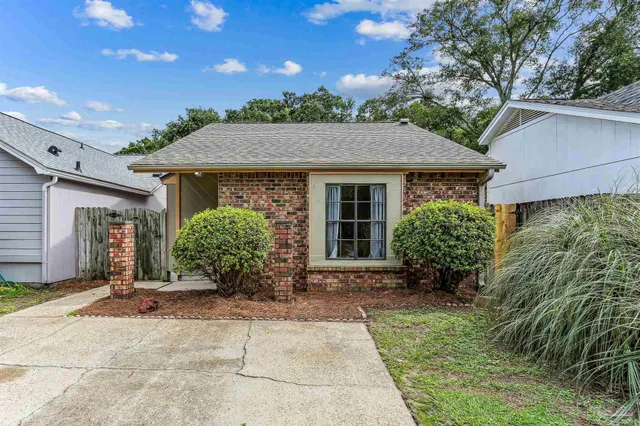 a backyard of a house with potted plants