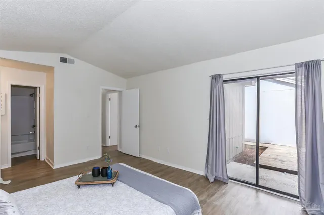 a bedroom with a bed and glass door