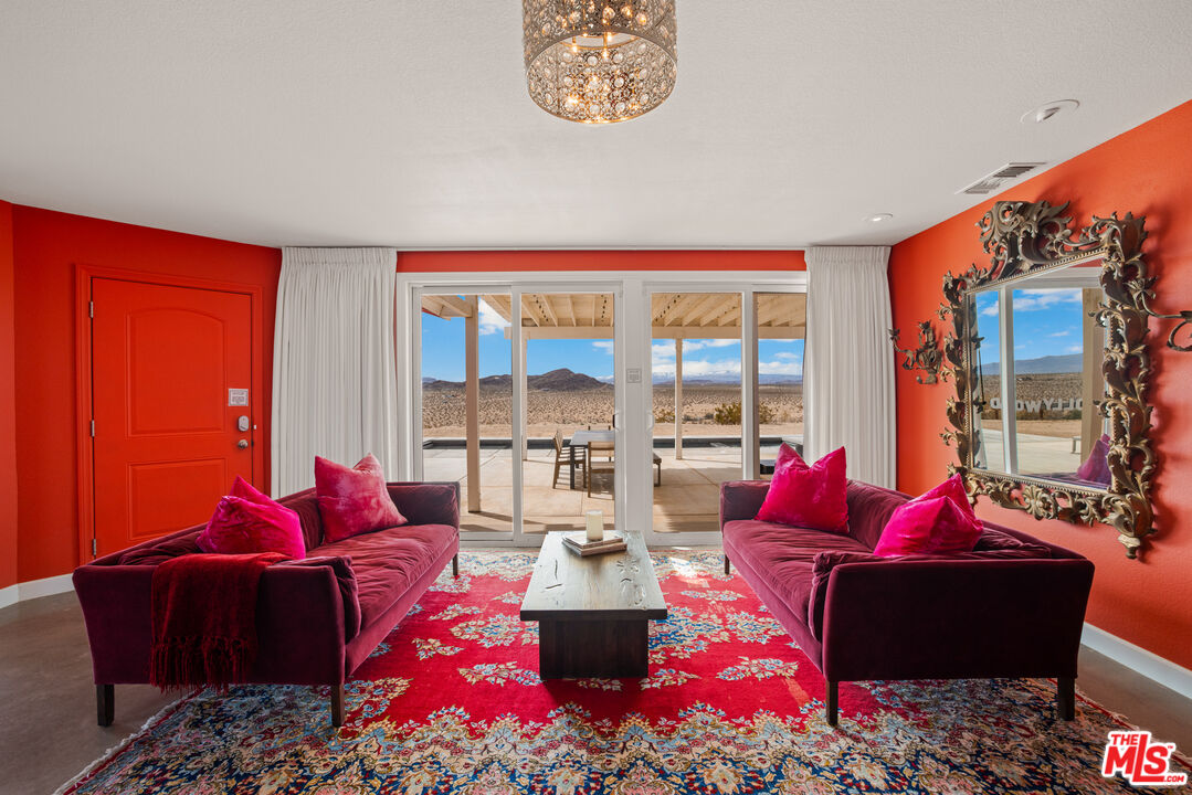 64425 Carot Road Joshua Tree, CA 92252 - Photo 14 of 73 a living room with furniture and a large window
