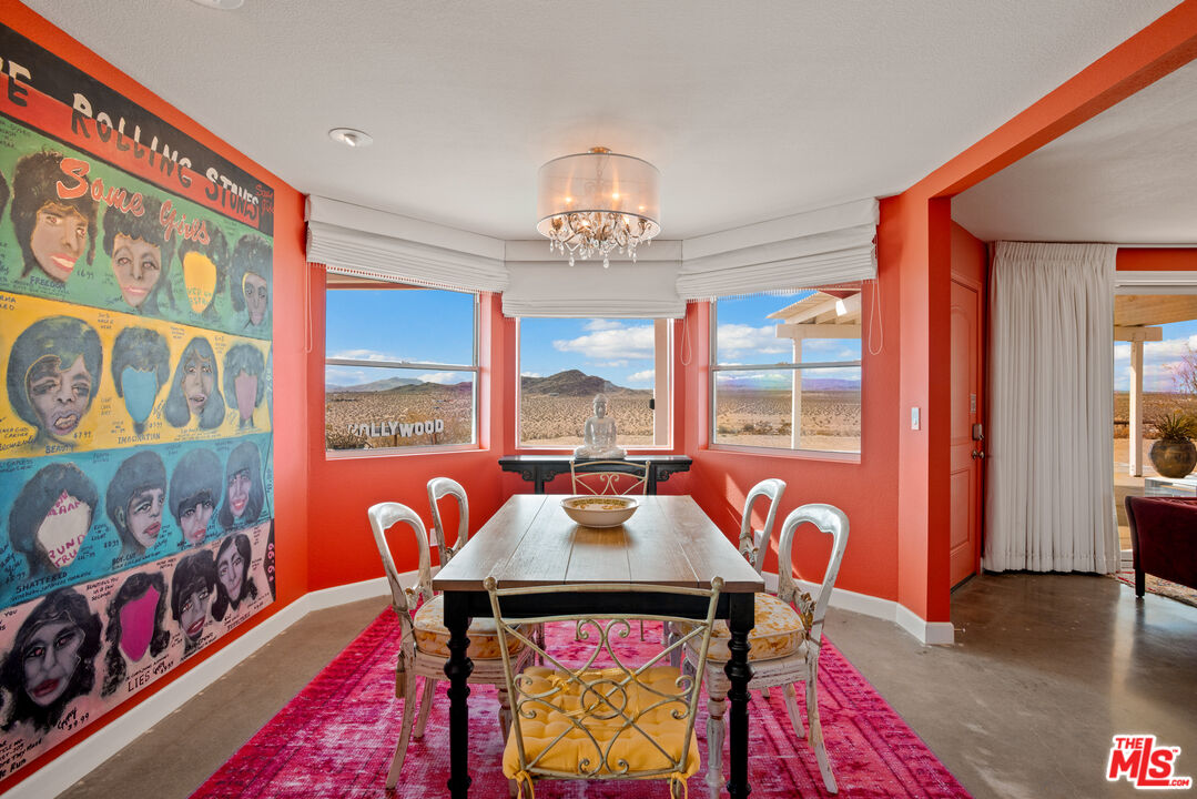 64425 Carot Road Joshua Tree, CA 92252 - Photo 20 of 73 a view of a dining room with furniture a chandelier and wooden floor