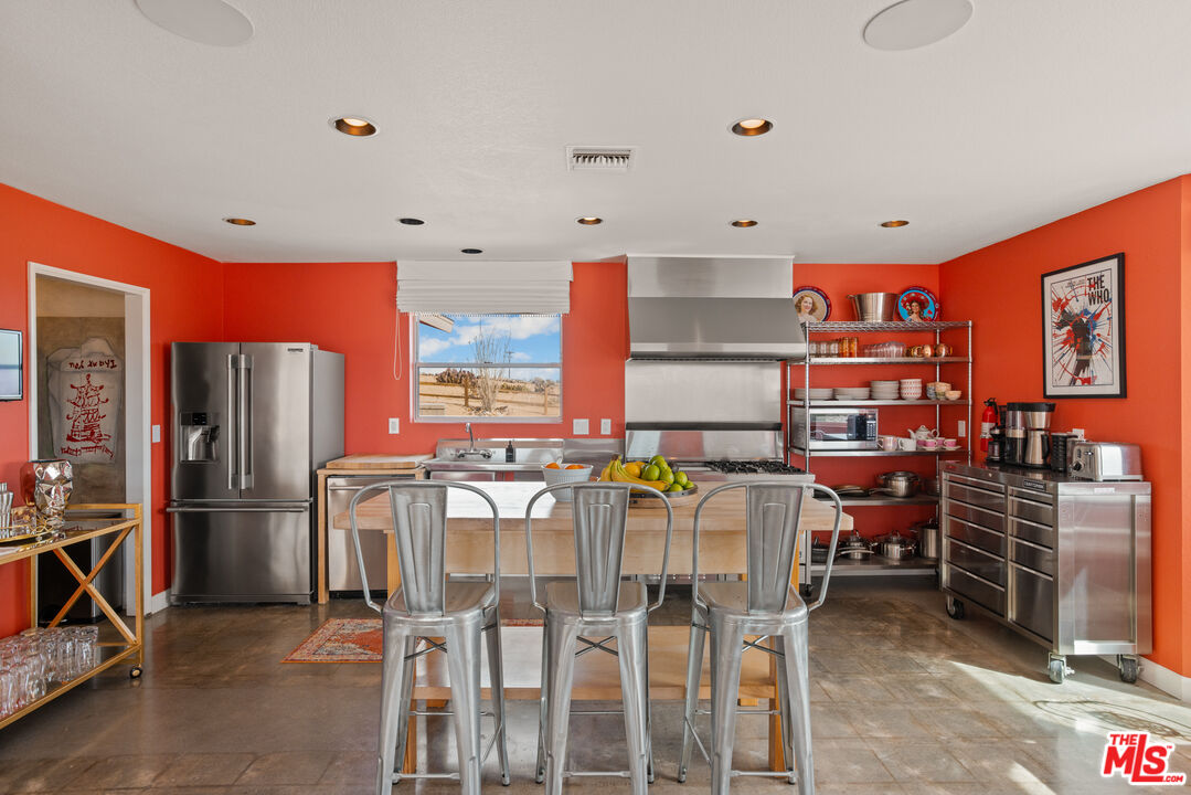 64425 Carot Road Joshua Tree, CA 92252 - Photo 22 of 73 a kitchen with stainless steel appliances kitchen island granite countertop a refrigerator and a stove top oven