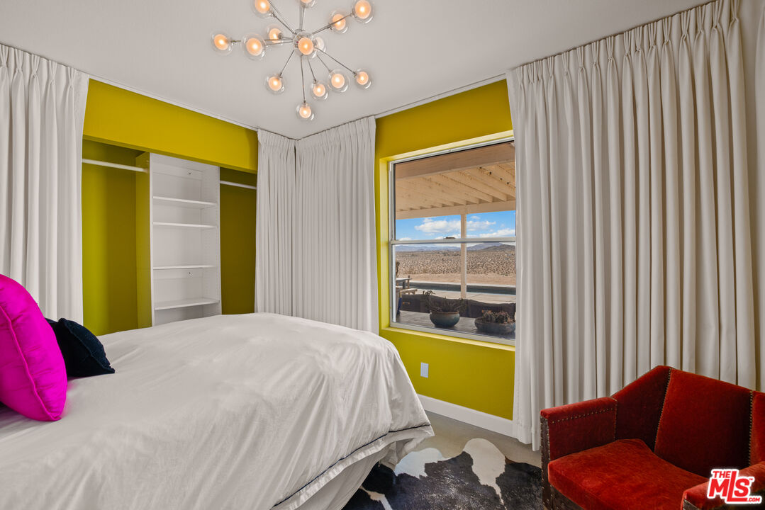 64425 Carot Road Joshua Tree, CA 92252 - Photo 29 of 73 a bedroom with a bed and a window