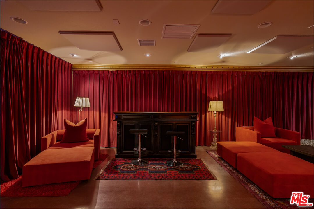 64425 Carot Road Joshua Tree, CA 92252 - Photo 40 of 73 a living room with furniture a fireplace and a projector