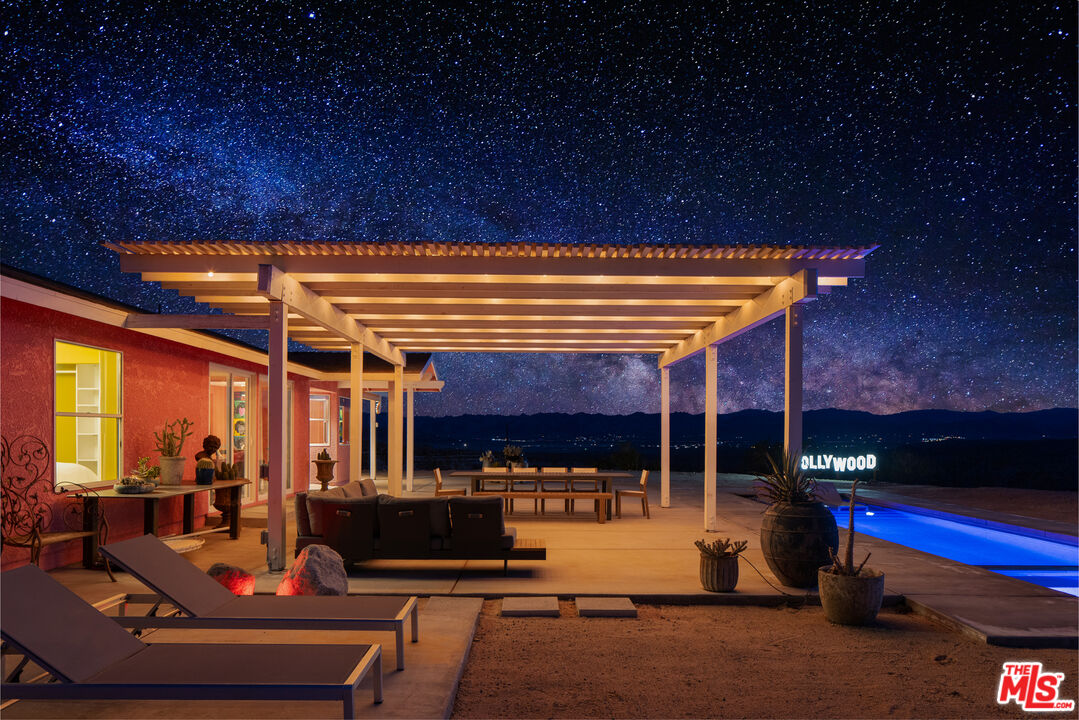 64425 Carot Road Joshua Tree, CA 92252 - Photo 69 of 73 a view of a patio with table and chairs barbeque potted plants and large tree