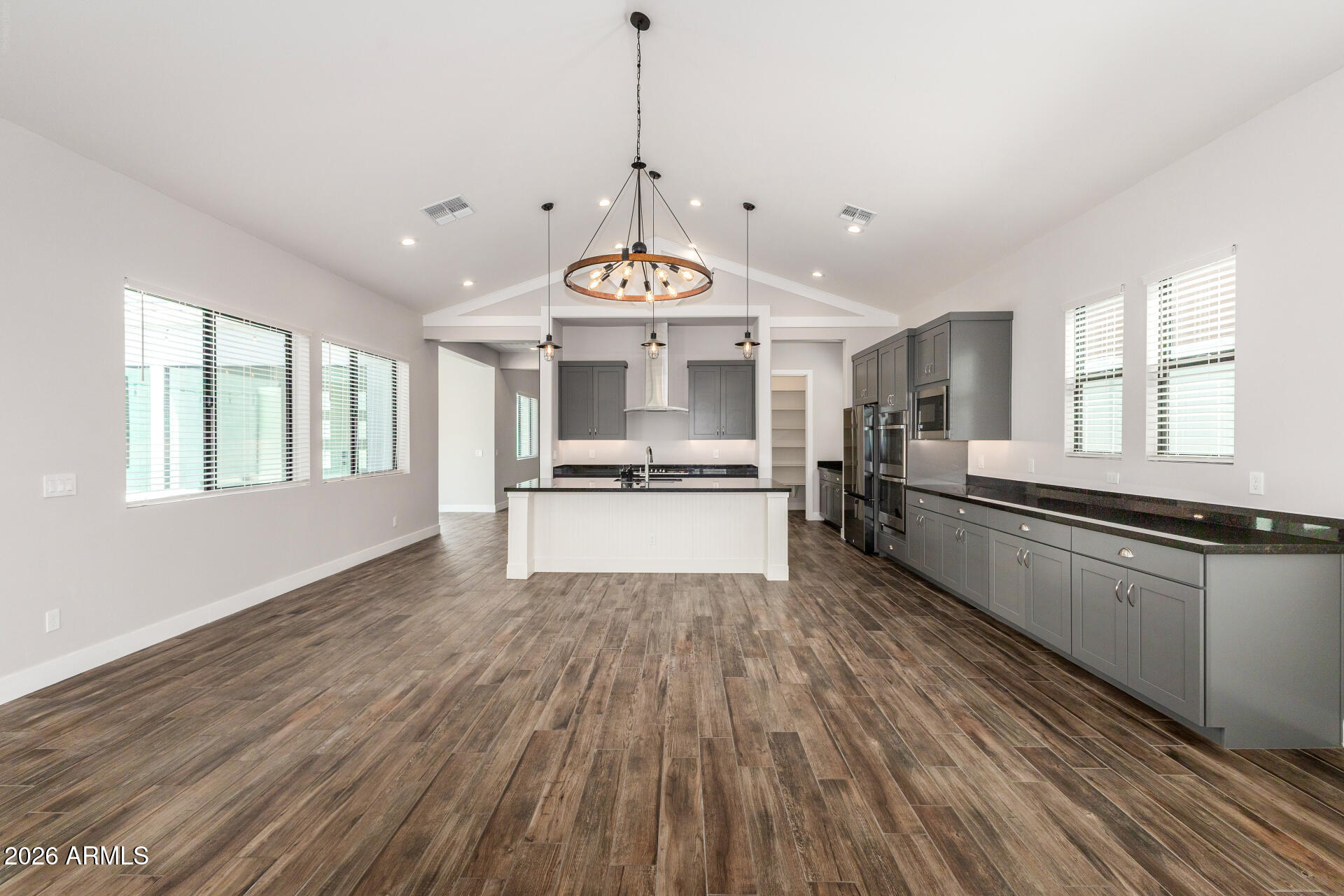 9818 South 7th Place Phoenix, AZ 85042 - Photo 13 of 62 a open kitchen with stainless steel appliances granite countertop a refrigerator a stove and a wooden floors