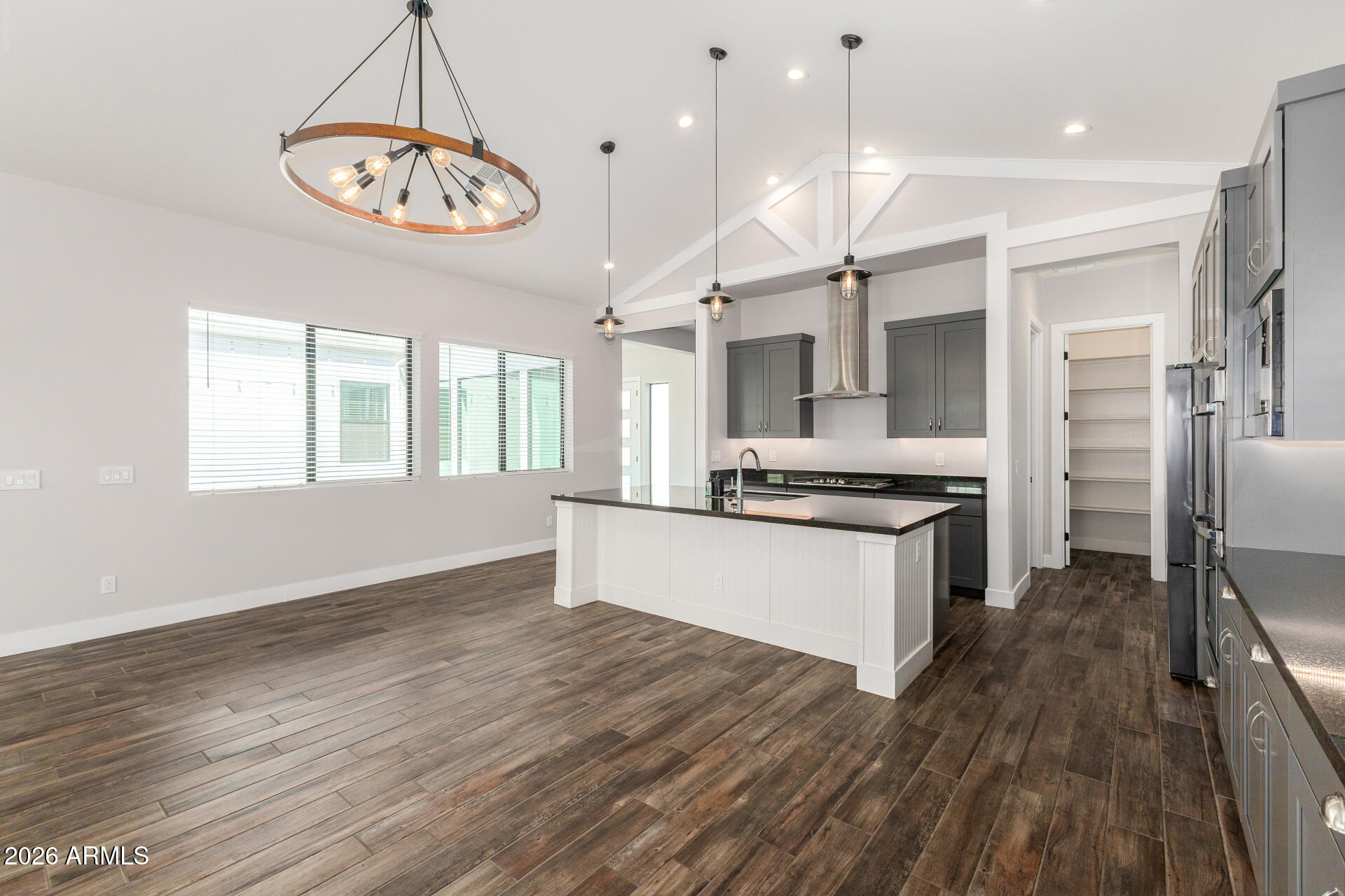 9818 South 7th Place Phoenix, AZ 85042 - Photo 14 of 62 a large kitchen with stainless steel appliances a large counter top a sink dishwasher a refrigerator and a stove