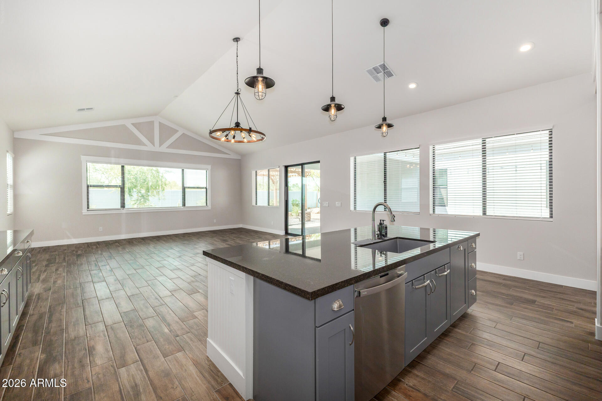 9818 South 7th Place Phoenix, AZ 85042 - Photo 15 of 62 a kitchen with center island wooden floor and a large window