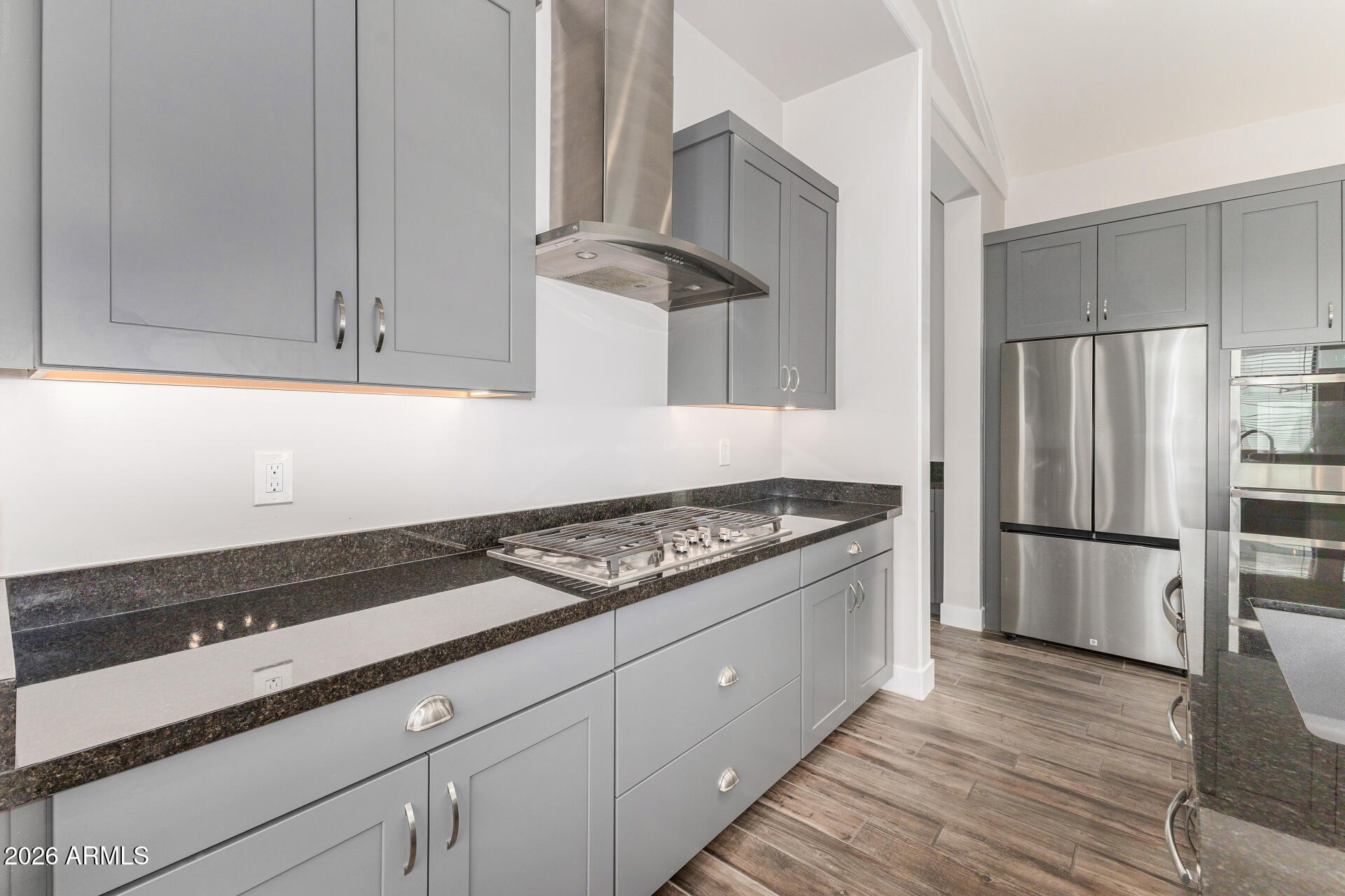 9818 South 7th Place Phoenix, AZ 85042 - Photo 16 of 62 a kitchen with granite countertop a stove and a refrigerator