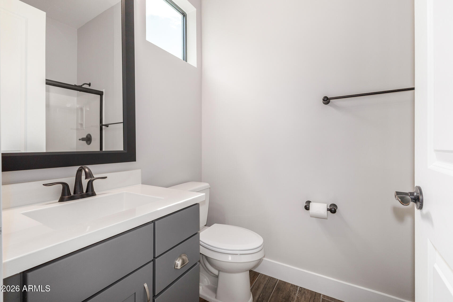 9818 South 7th Place Phoenix, AZ 85042 - Photo 31 of 62 a bathroom with a toilet sink and mirror