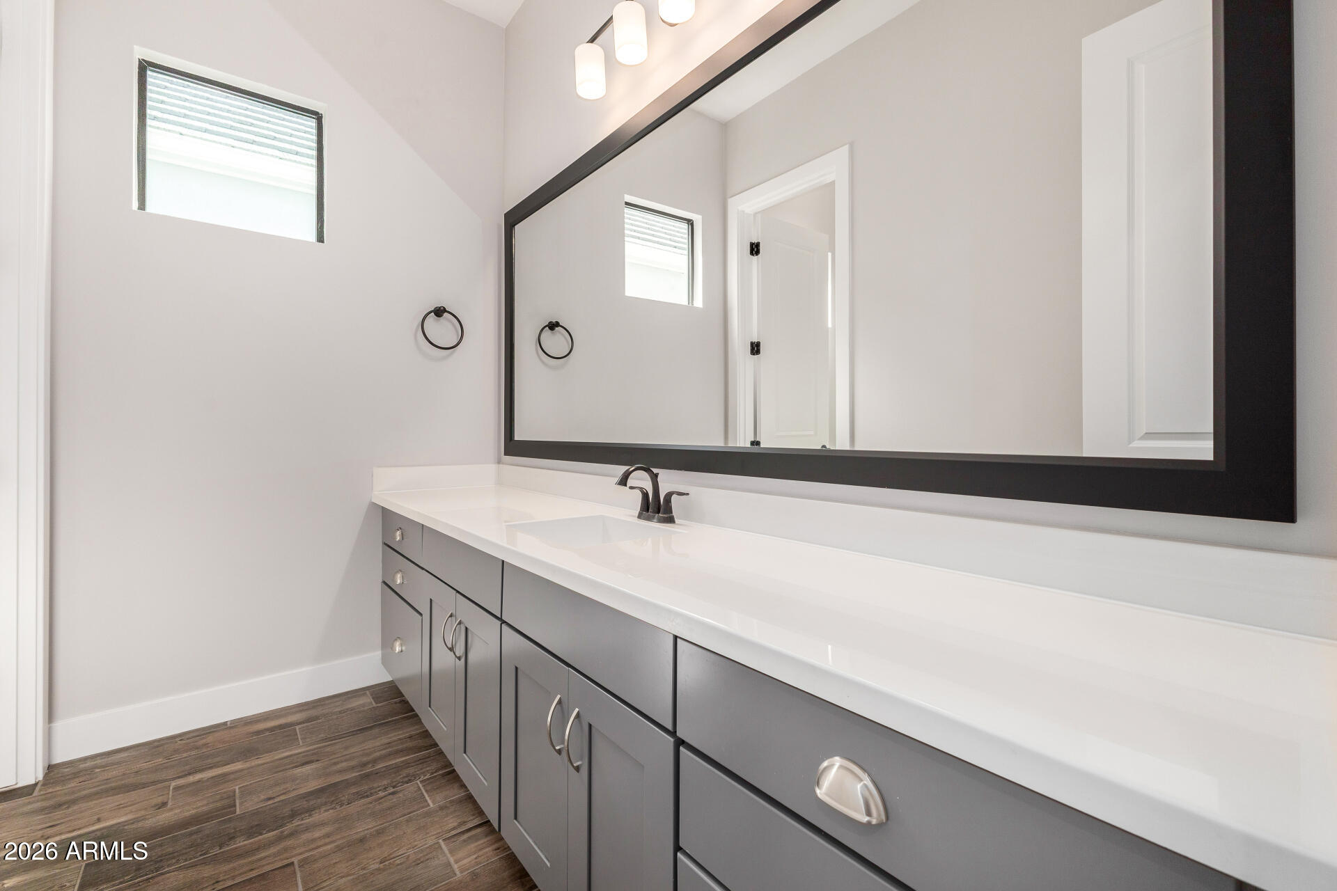 9818 South 7th Place Phoenix, AZ 85042 - Photo 32 of 62 a bathroom with a sink and a mirror