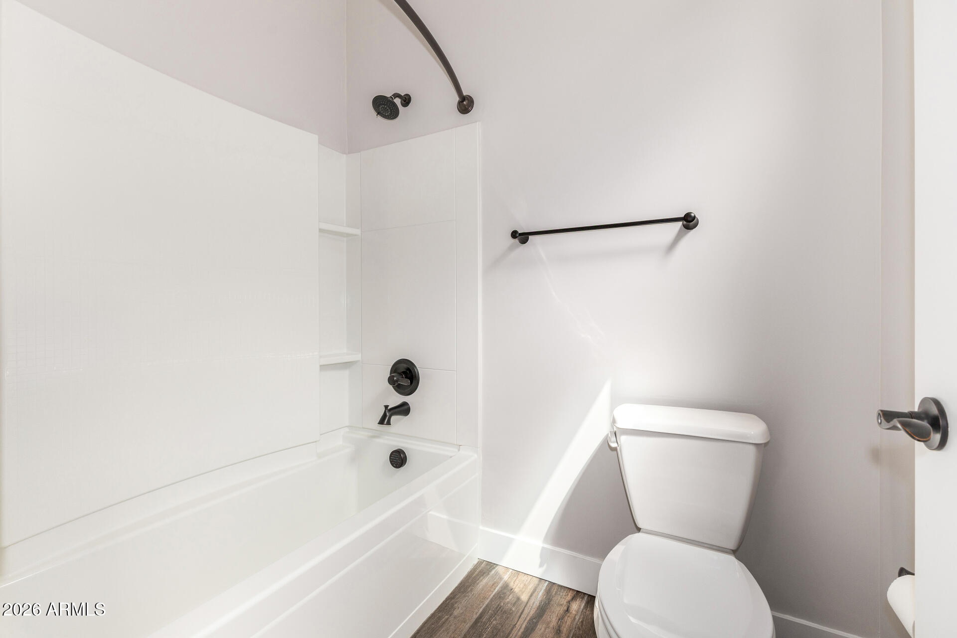 9818 South 7th Place Phoenix, AZ 85042 - Photo 33 of 62 a bathroom with a toilet and a bathtub