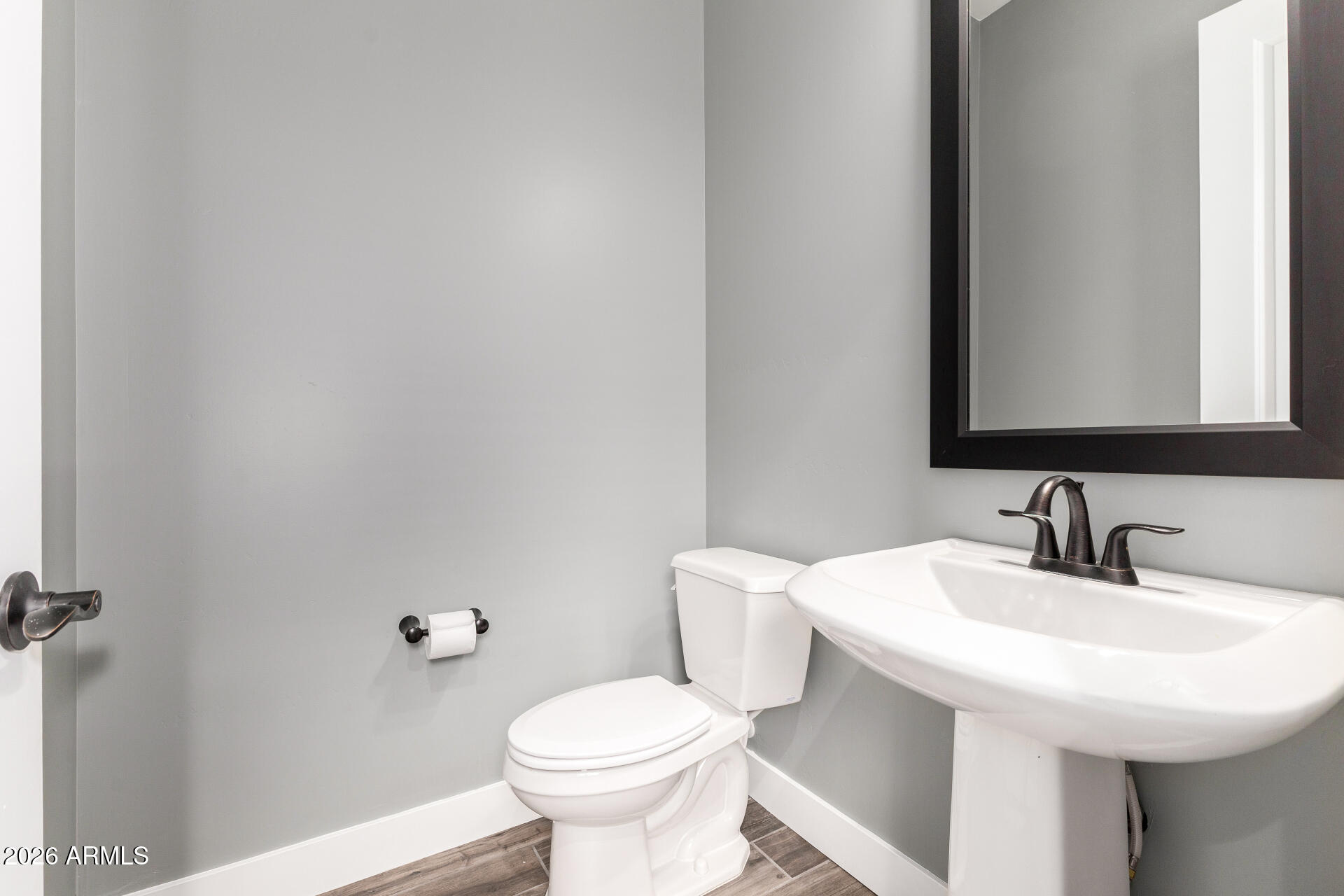 9818 South 7th Place Phoenix, AZ 85042 - Photo 35 of 62 a bathroom with a sink a toilet and mirror