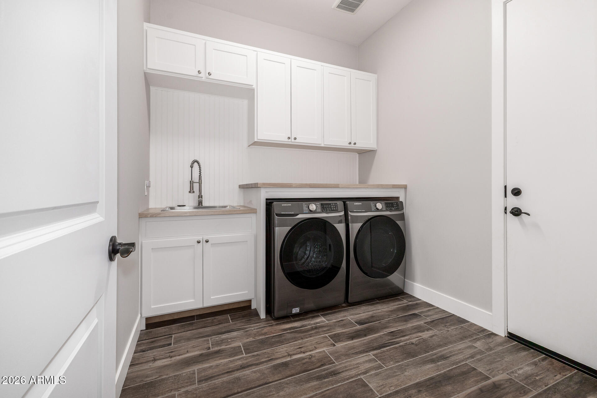 9818 South 7th Place Phoenix, AZ 85042 - Photo 36 of 62 a view of a storage and utility room with washer and dryer