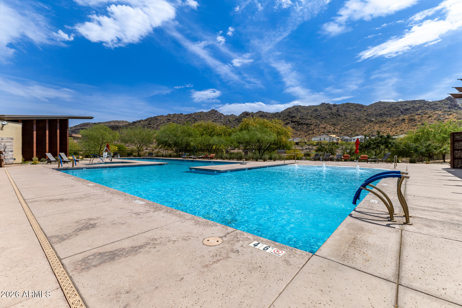 9818 South 7th Place Phoenix, AZ 85042 - Photo 58 of 62 a view of a swimming pool with a table and chairs