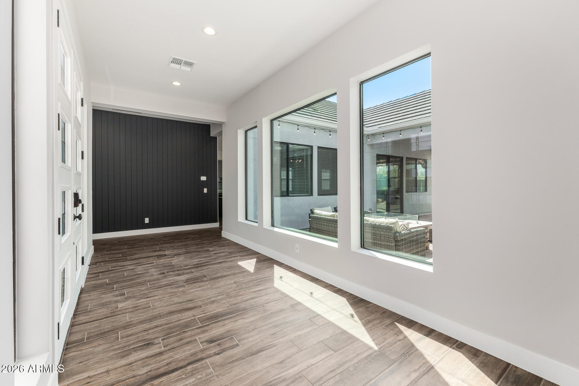 9818 South 7th Place Phoenix, AZ 85042 - Photo 7 of 62 a view of a hallway with wooden floor and a window
