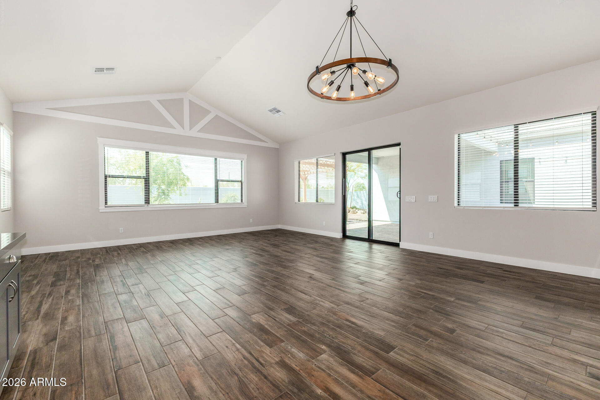 9818 South 7th Place Phoenix, AZ 85042 - Photo 8 of 62 an empty room with wooden floor and windows