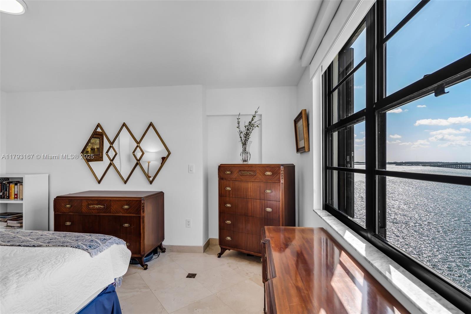 2333 Brickell Avenue, Unit 1401 Miami, FL 33129 - Photo 15 of 36 a bedroom with a bed and a window