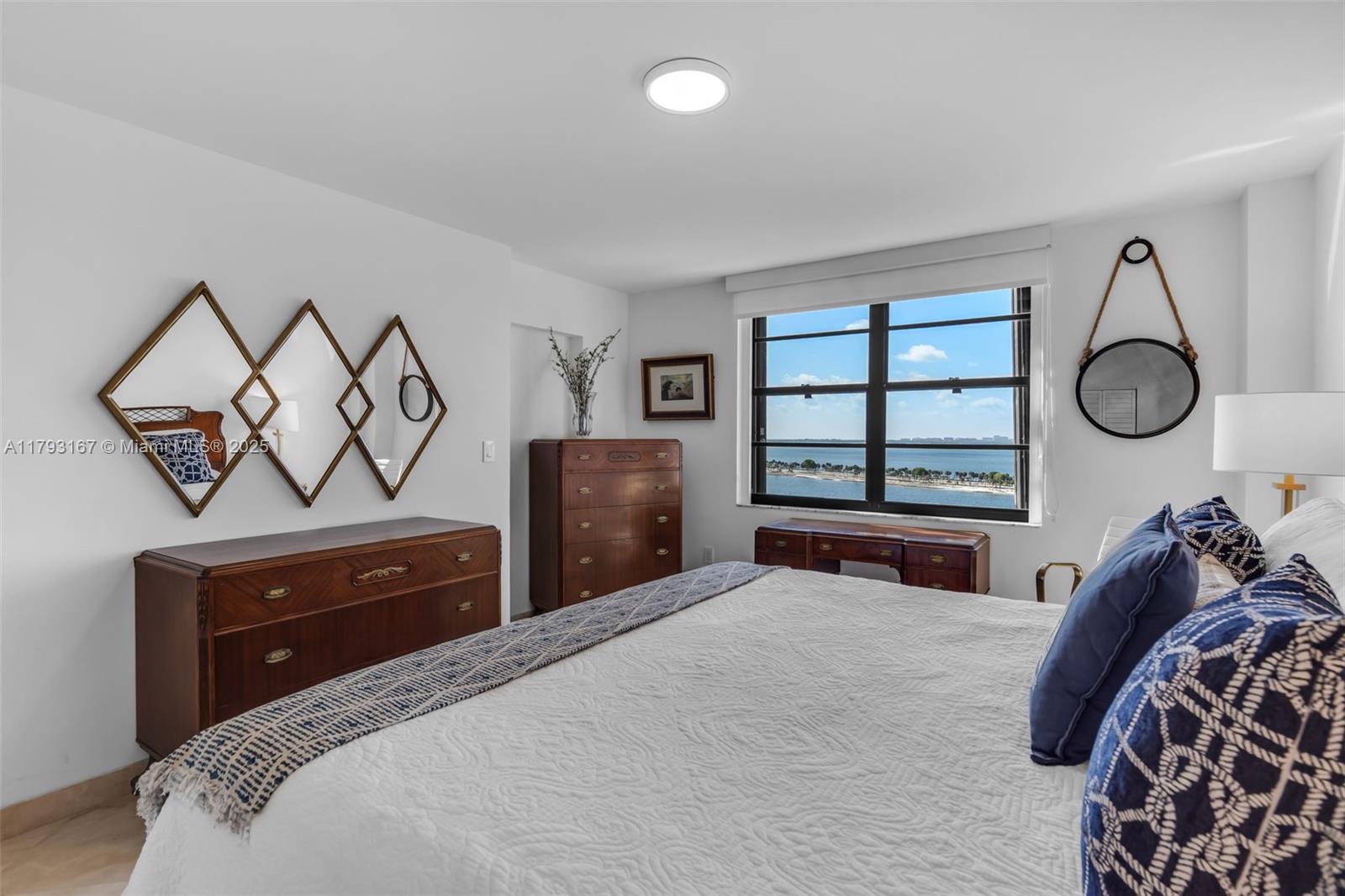 2333 Brickell Avenue, Unit 1401 Miami, FL 33129 - Photo 16 of 36 a bedroom with a bed and a window