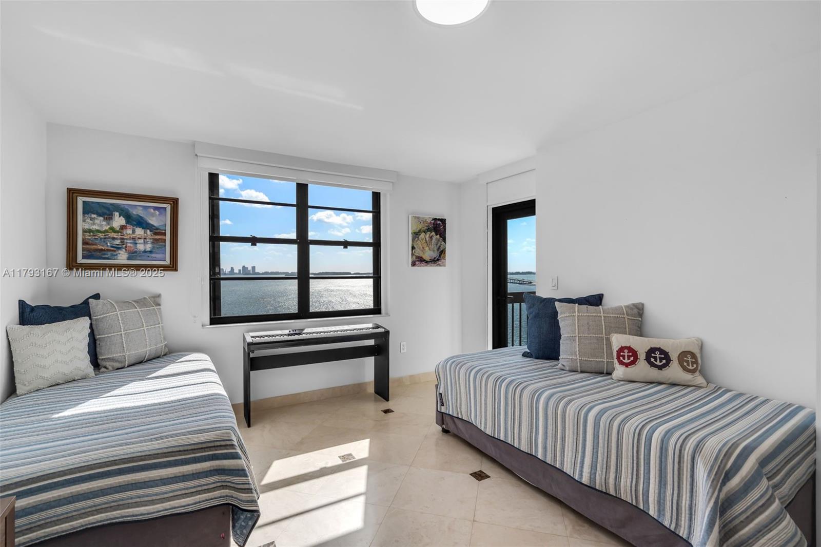 2333 Brickell Avenue, Unit 1401 Miami, FL 33129 - Photo 19 of 36 a bedroom with a bed and a window