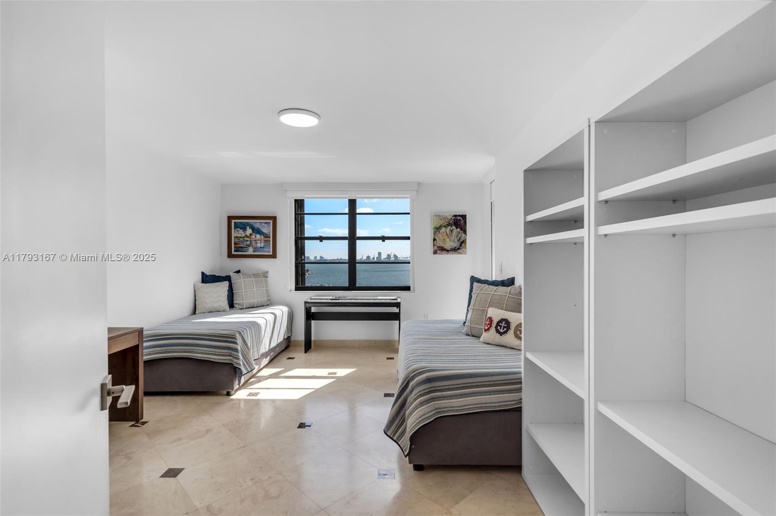 2333 Brickell Avenue, Unit 1401 Miami, FL 33129 - Photo 20 of 36 a bedroom with furniture and a window