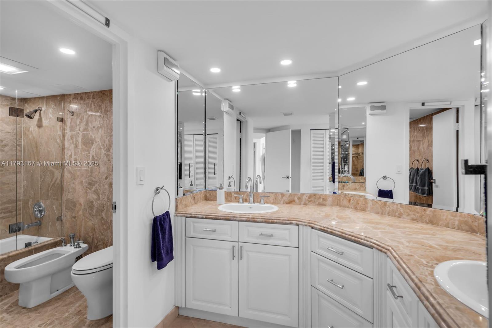 2333 Brickell Avenue, Unit 1401 Miami, FL 33129 - Photo 22 of 36 a bathroom with a granite countertop sink mirror vanity and toilet