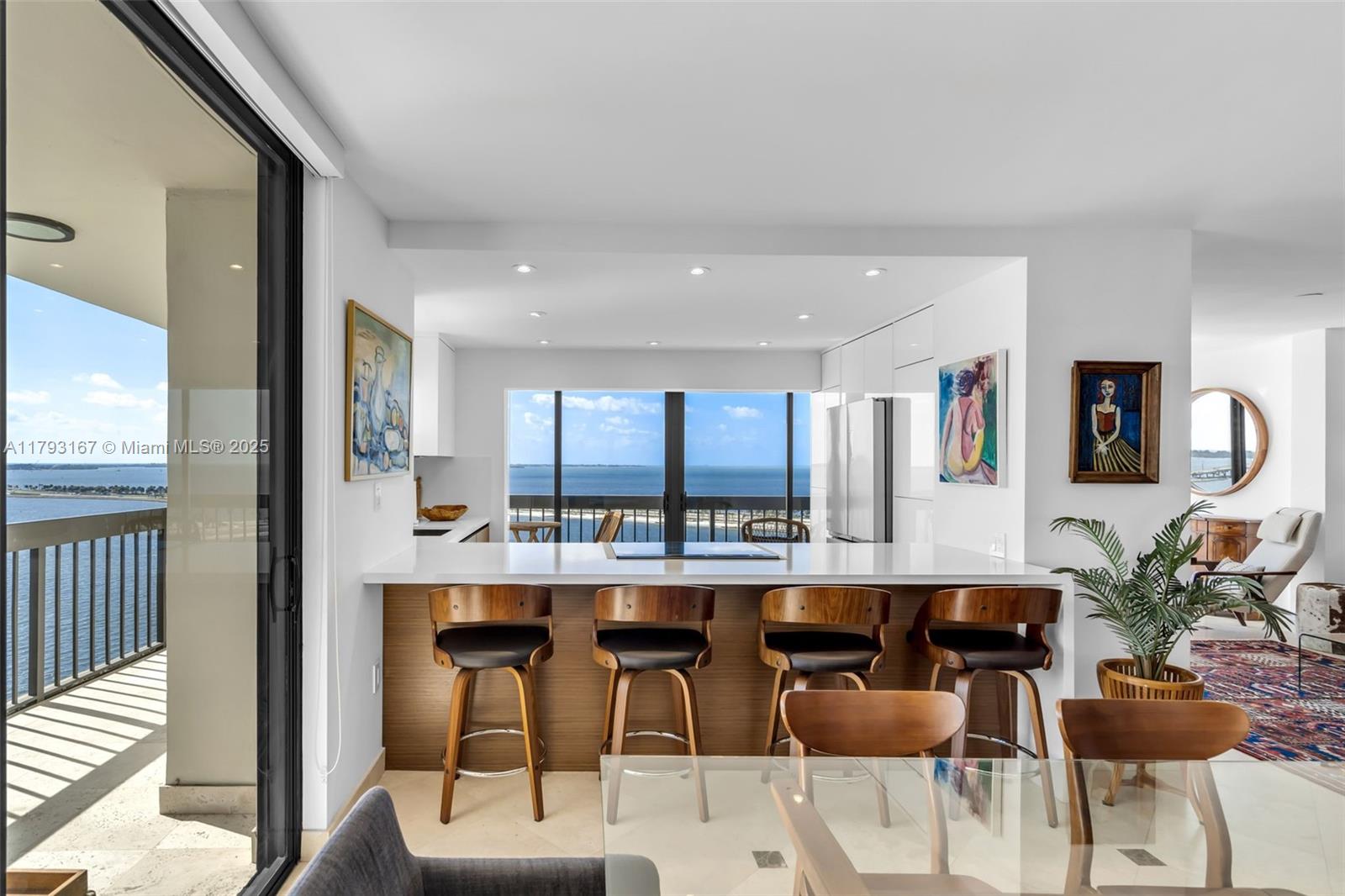 2333 Brickell Avenue, Unit 1401 Miami, FL 33129 - Photo 6 of 36 a room with stainless steel appliances kitchen island granite countertop a dining table chairs and view living room