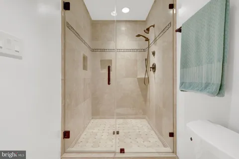 a bathroom with a glass shower door