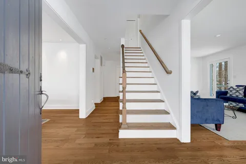 a view of entryway and hall with wooden floor