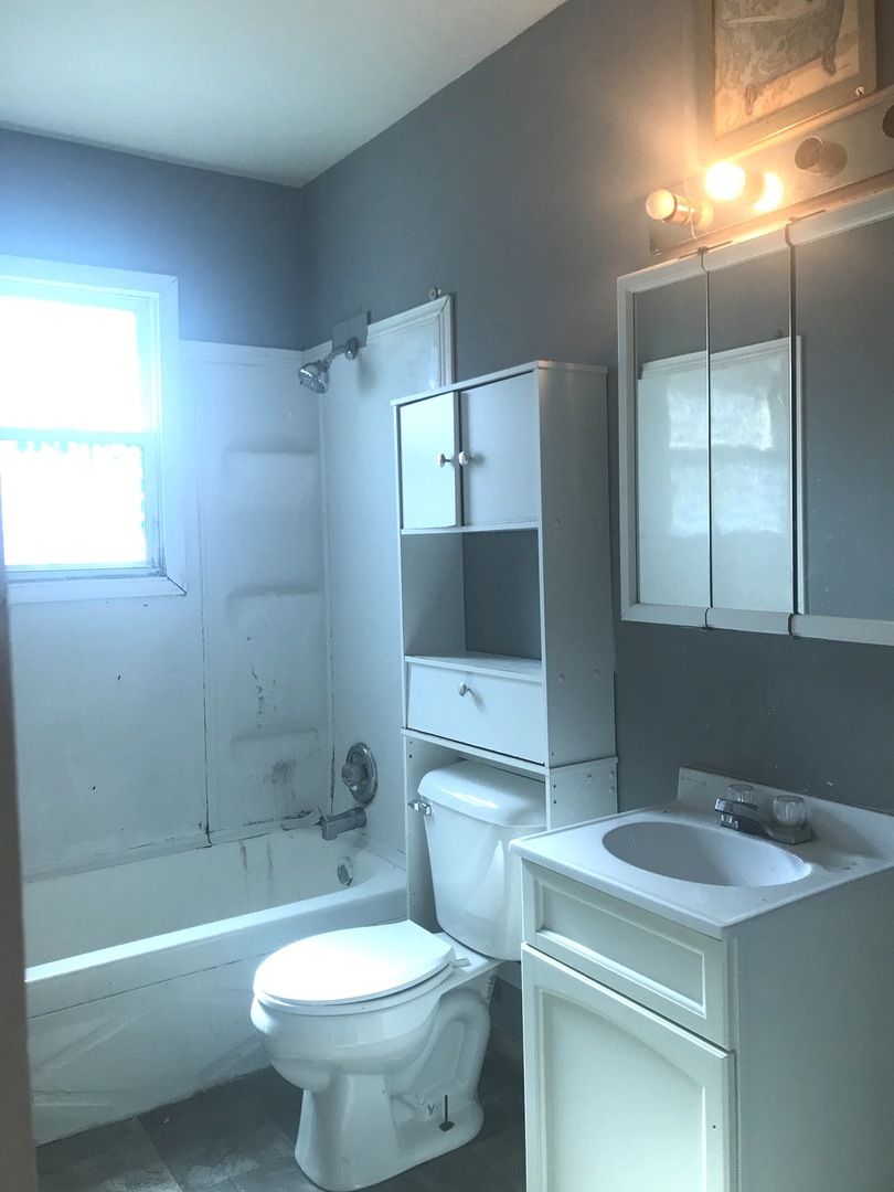 167 Seabury Road Bolingbrook, IL 60440 - Photo 14 of 17 a bathroom with a sink toilet a mirror and bathtub