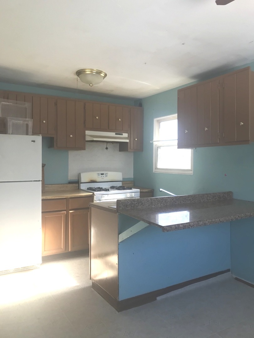 167 Seabury Road Bolingbrook, IL 60440 - Photo 8 of 17 a kitchen with kitchen island granite countertop a sink stove and cabinets