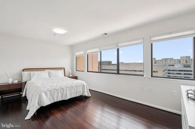 a bedroom with a bed and a large window