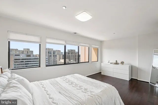 a bedroom with a bed and a large window