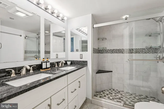 a bathroom with a double vanity sink mirror double shower and a bathtub