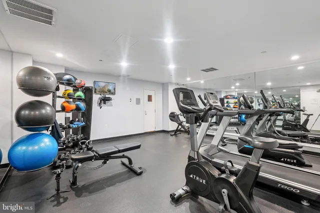 a living room with furniture and large windows