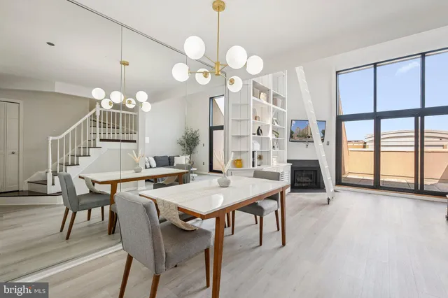a view of a a dining room with furniture window and wooden floor