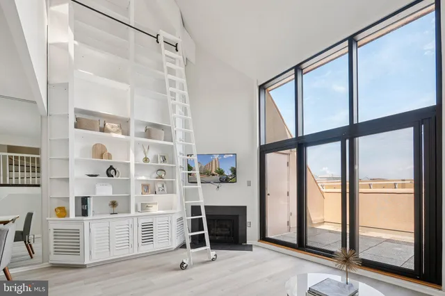 a view of front door with wooden floor and windows