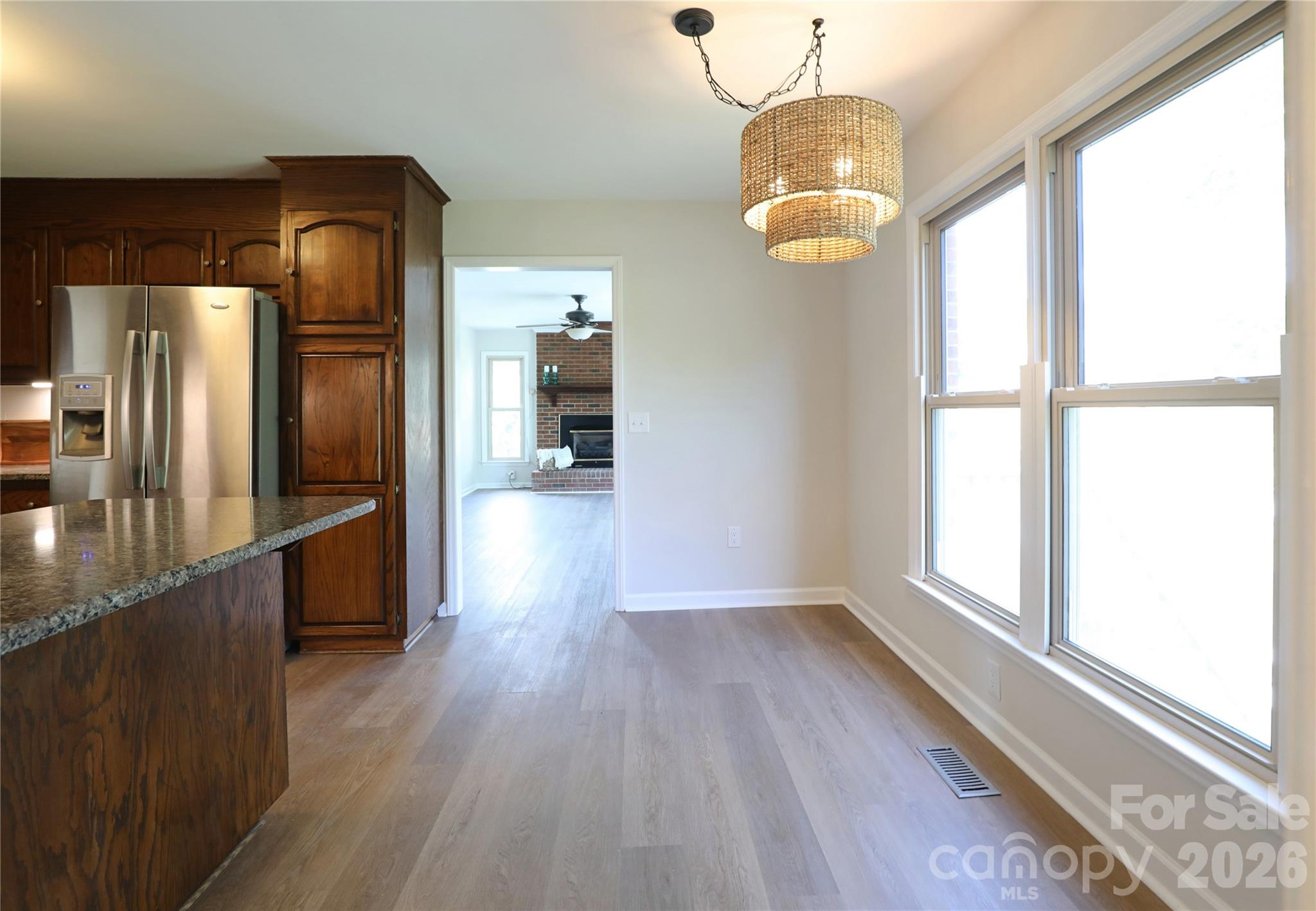 12809 Pine Bluff Road Midland, NC 28107 - Photo 12 of 41 a view of a room with wooden floor chandeliers