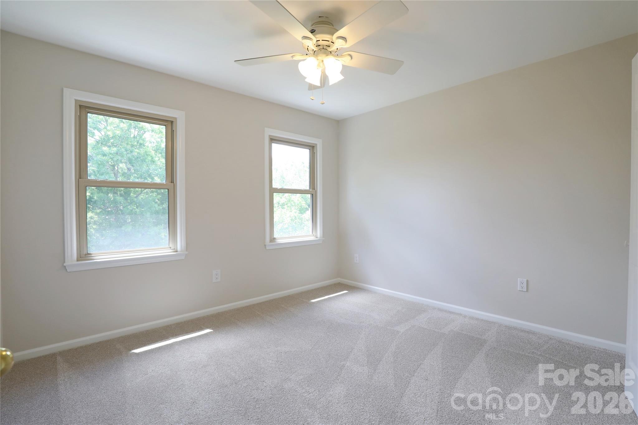 12809 Pine Bluff Road Midland, NC 28107 - Photo 25 of 41 an empty room with a window and a fan
