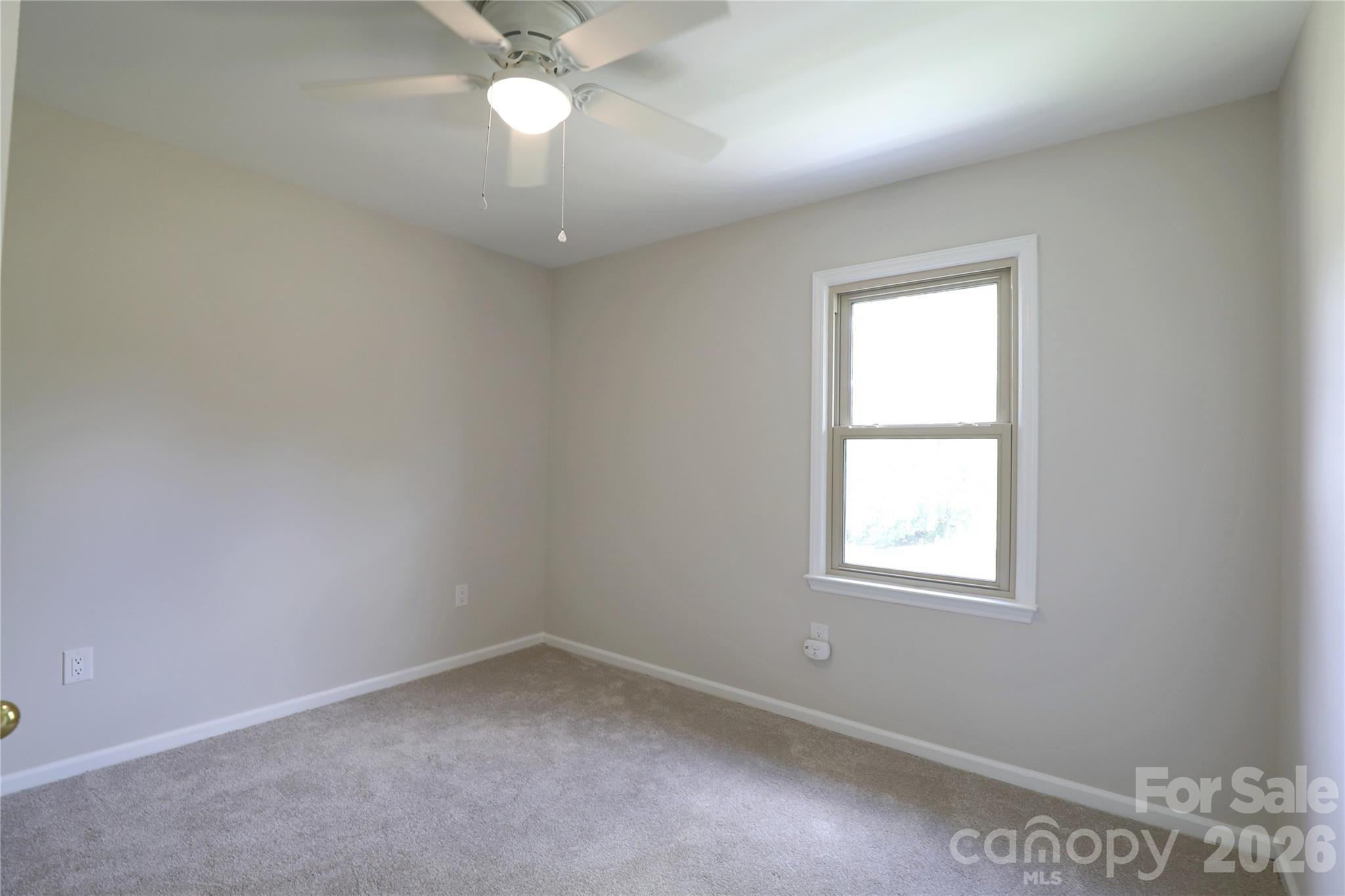 12809 Pine Bluff Road Midland, NC 28107 - Photo 30 of 41 an empty room with a window and a fan