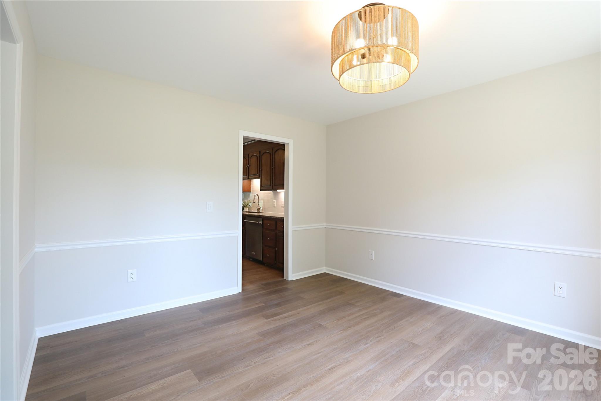 12809 Pine Bluff Road Midland, NC 28107 - Photo 4 of 41 an empty room with wooden floor and windows