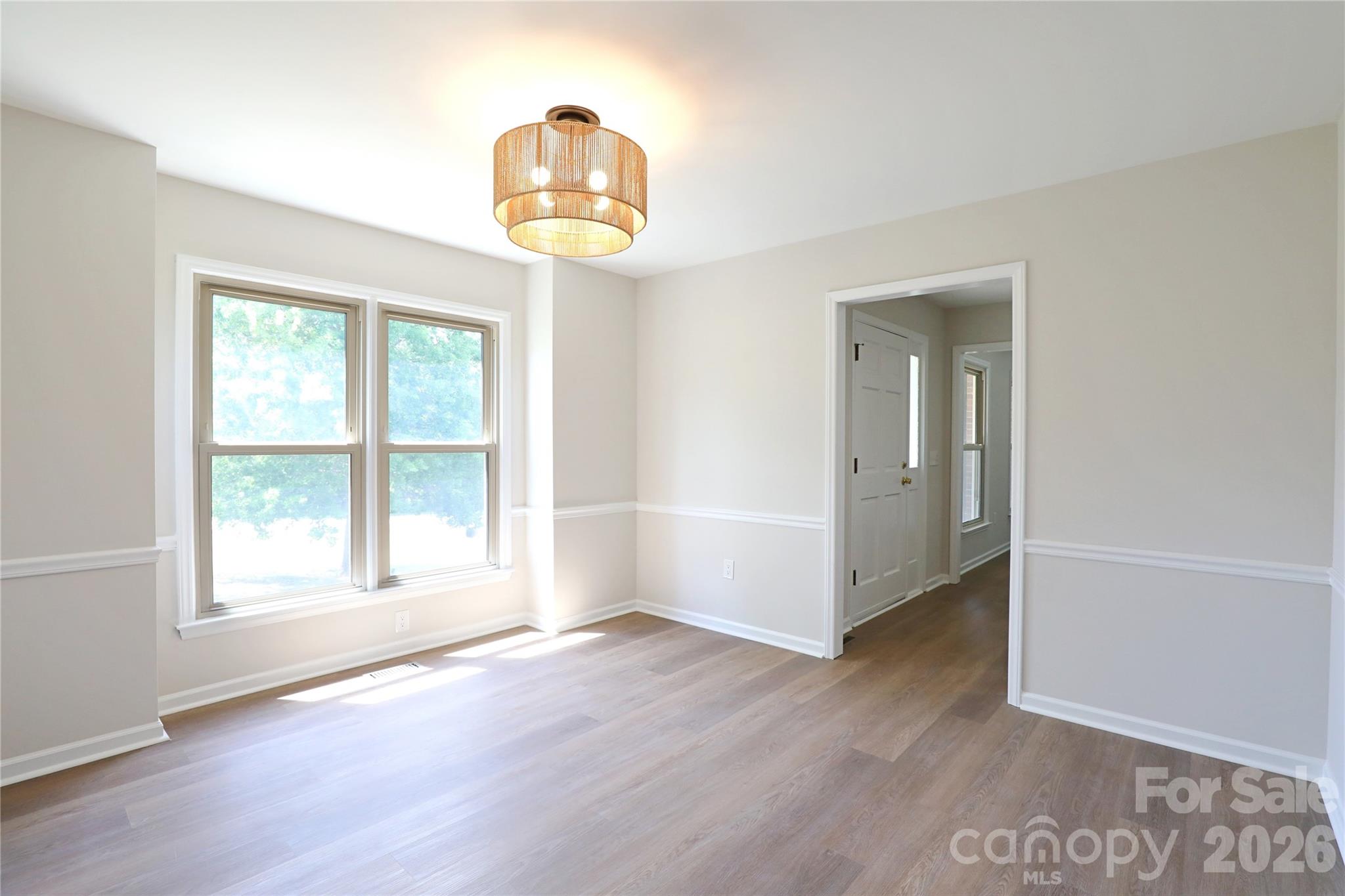 12809 Pine Bluff Road Midland, NC 28107 - Photo 5 of 41 an empty room with wooden floor and window