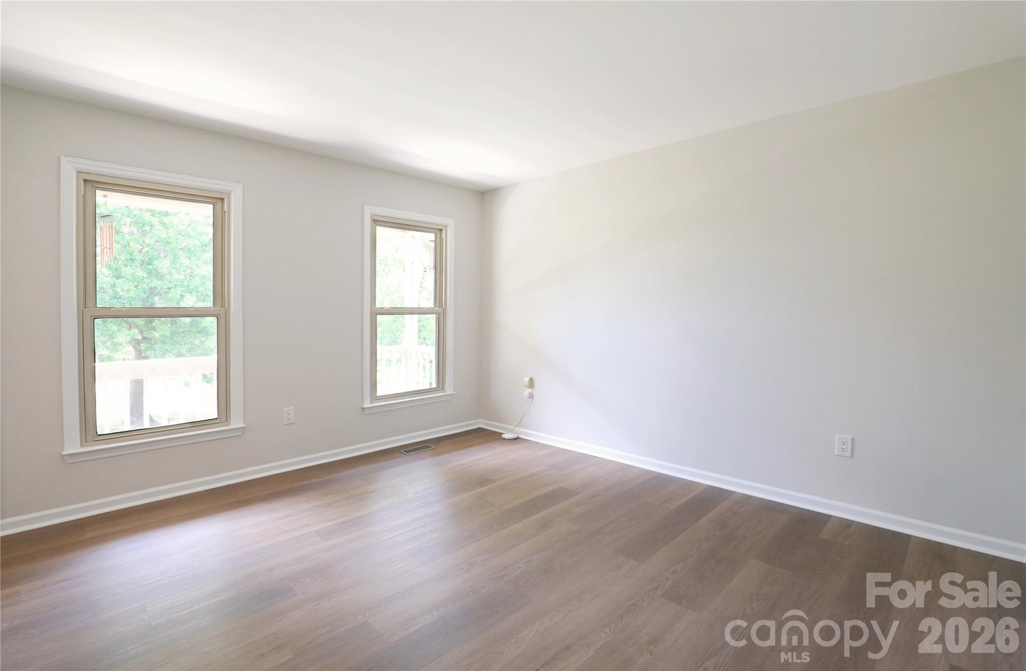 12809 Pine Bluff Road Midland, NC 28107 - Photo 6 of 41 an empty room with wooden floor and windows